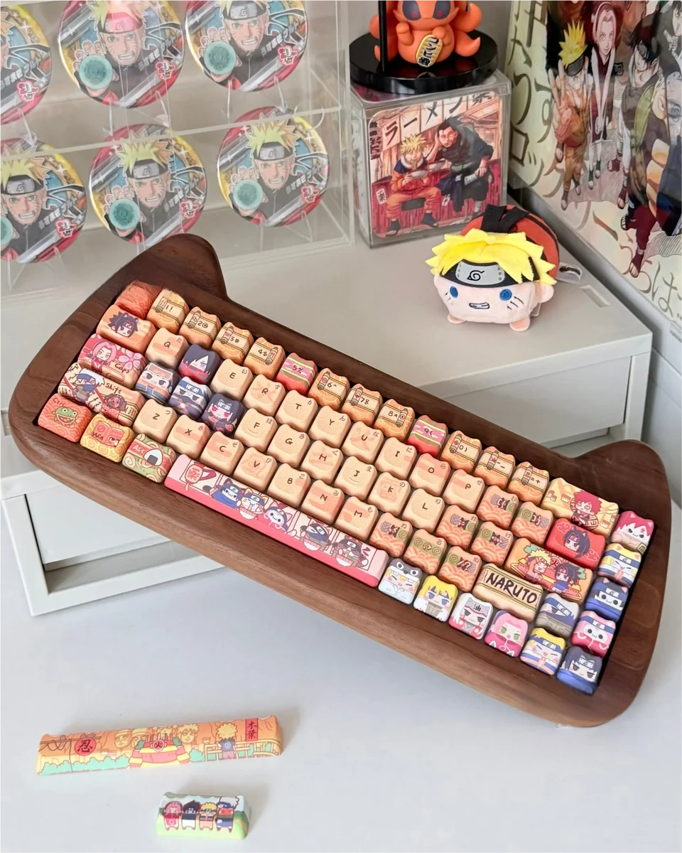 Artistic Naruto PBT dye-sub keycaps set displayed from various angles, featuring vibrant anime characters and ninja symbols to unleash your inner ninja.