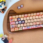 Vibrant Naruto PBT dye-sub keycaps set, artistically showcasing iconic anime characters and ninja symbols from various angles. An immersive set to unleash ninja spirit.