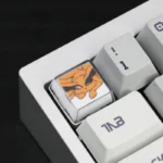 A close-up view of the serene Naruto and Kurama handcrafted resin keycap set, showcasing its vibrant details and artistic craftsmanship from a unique design.