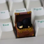 Handcrafted Niffler artisan resin keycap, intricately sculpted. Rich dark tones and whimsical fantasy charm define this detailed Niffler keycap's artistic design.