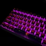 A close-up view of the translucent PBT Night Sky keycaps set, showcasing the ethereal glow of side-engraved legends against a cosmic backdrop, evoking setup.