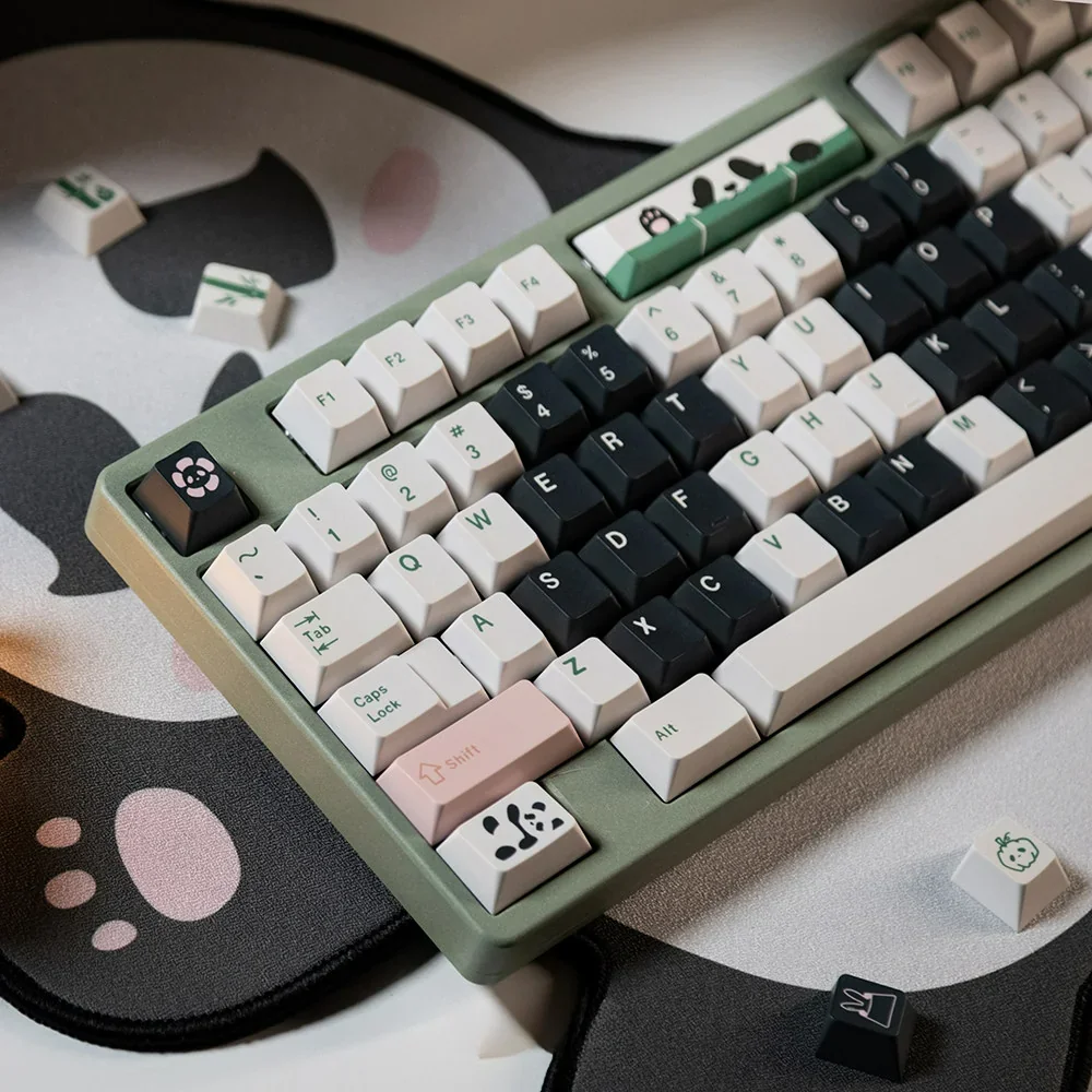 Panda PBT keycaps set in a playful aesthetic, warm hues. Showcases durable PBT, crisp dye-sub legends, and unique artistic panda motifs.