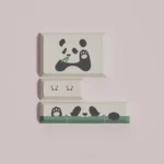Panda PBT keycaps set from various angles, showcasing the playful aesthetic. Highlights durable PBT and crisp dye-sub legends in a warm hues.