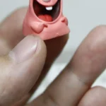 Close-up of a handcrafted Patrick Star resin keycap, showcasing its vibrant, detailed sculpting and nostalgic SpongeBob expression from a unique angle.