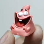 Handcrafted grinning Patrick Star resin keycap, a vibrant and playful novelty, capturing a nostalgic SpongeBob expression for mechanical keyboards.