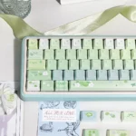 Multiple views of the Gardenia Green Grape Series Keycap Set, showcasing its fresh muted green, creamy white, and premium finish.