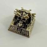 Handcrafted brass skull keycap, an intricate Pharaoh Punk design inspired by ancient Egyptian mystique for a premium desktop statement.