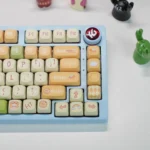 Explore the adorable Pig Pilot PBT MOA keycap set from various angles, showcasing charming pig pilots, fluffy clouds, and playful aviation motifs.