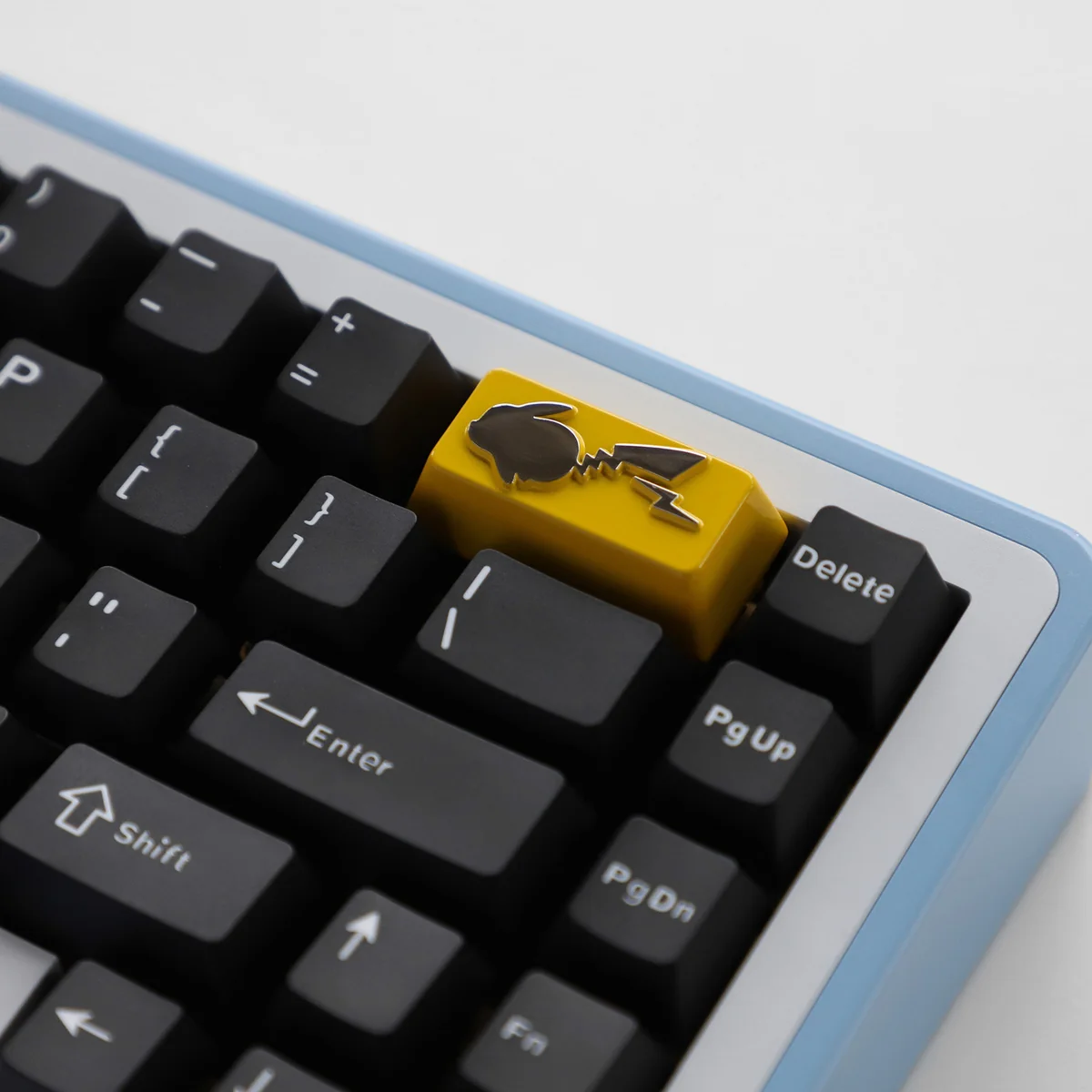 Premium zinc alloy Pikachu backspace keycap showcasing intricate design from multiple angles, a collectible for nostalgic keyboard enthusiasts.