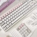 A collection of Dazed Cat Keycap Set images showcasing various angles and vibrant backlit options, highlighting the whimsical charm and adorable pastel setup.