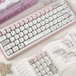Dazed Cat Keycap Set in a charming, whimsical display, showcasing its adorable pastel design and versatile backlit options from different angles.