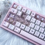 A playful gallery of iconic Miffy PBT dye-sub translucent keycaps set, showcasing charming pink illustrations and side-printed details from various angle.