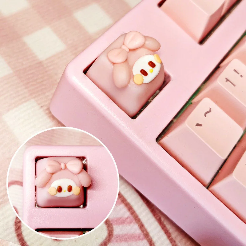 Close-up of a whimsical handmade artisan My Melody keycap for keyboards, featuring adorable pastel hues with intricate, handcrafted detailed setup.