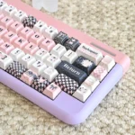 Sweetheart Pink PBT Keycaps set in a charming pastel design, showcasing playful dye-sub legends and the adorable custom set from a unique angle.