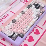 Close-up of adorable Sweetheart Pink PBT keycaps set showcasing playful dye-sub legends and charming pastel hues, perfect for custom keyboards.