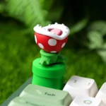 Vibrant, handcrafted Super Mario Piranha Plant keycap from a unique angle, highlighting its intricate layered resin details and interactive rotating design.