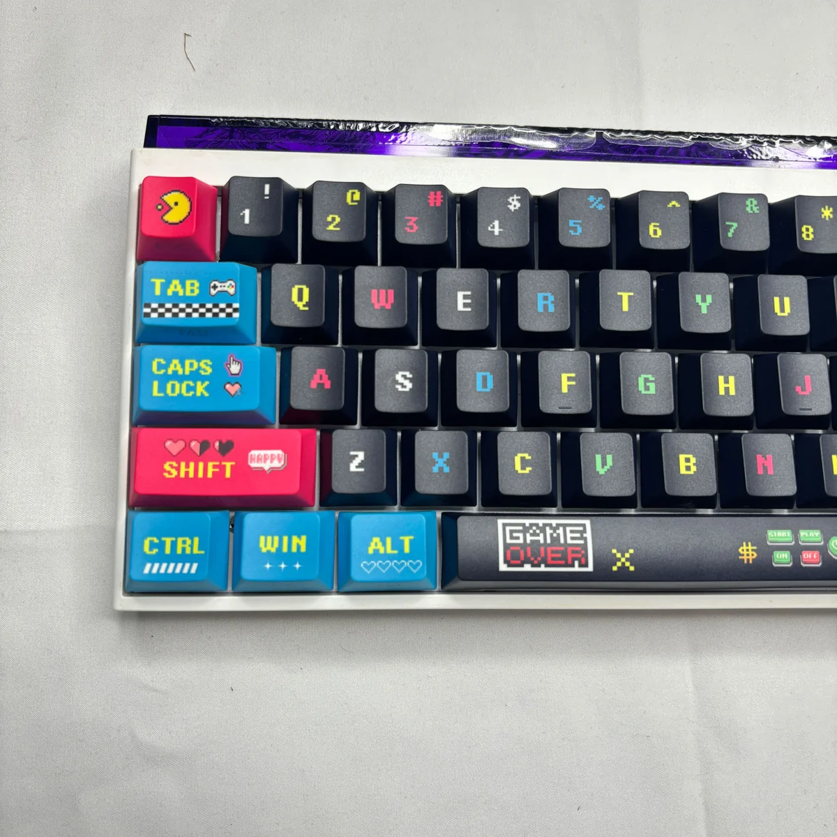 Pixel Keycaps Set: Retro Arcade PBT Side-Lit Set gallery, showcasing vibrant pixel art and dynamic translucent legends from multiple playful angles.