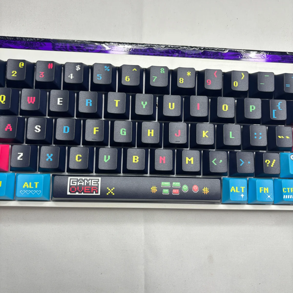 Vibrant Pixel Video Games Keycap Set gallery featuring playful retro arcade pixel art and glowing side-lit translucent PBT legends from various angles.