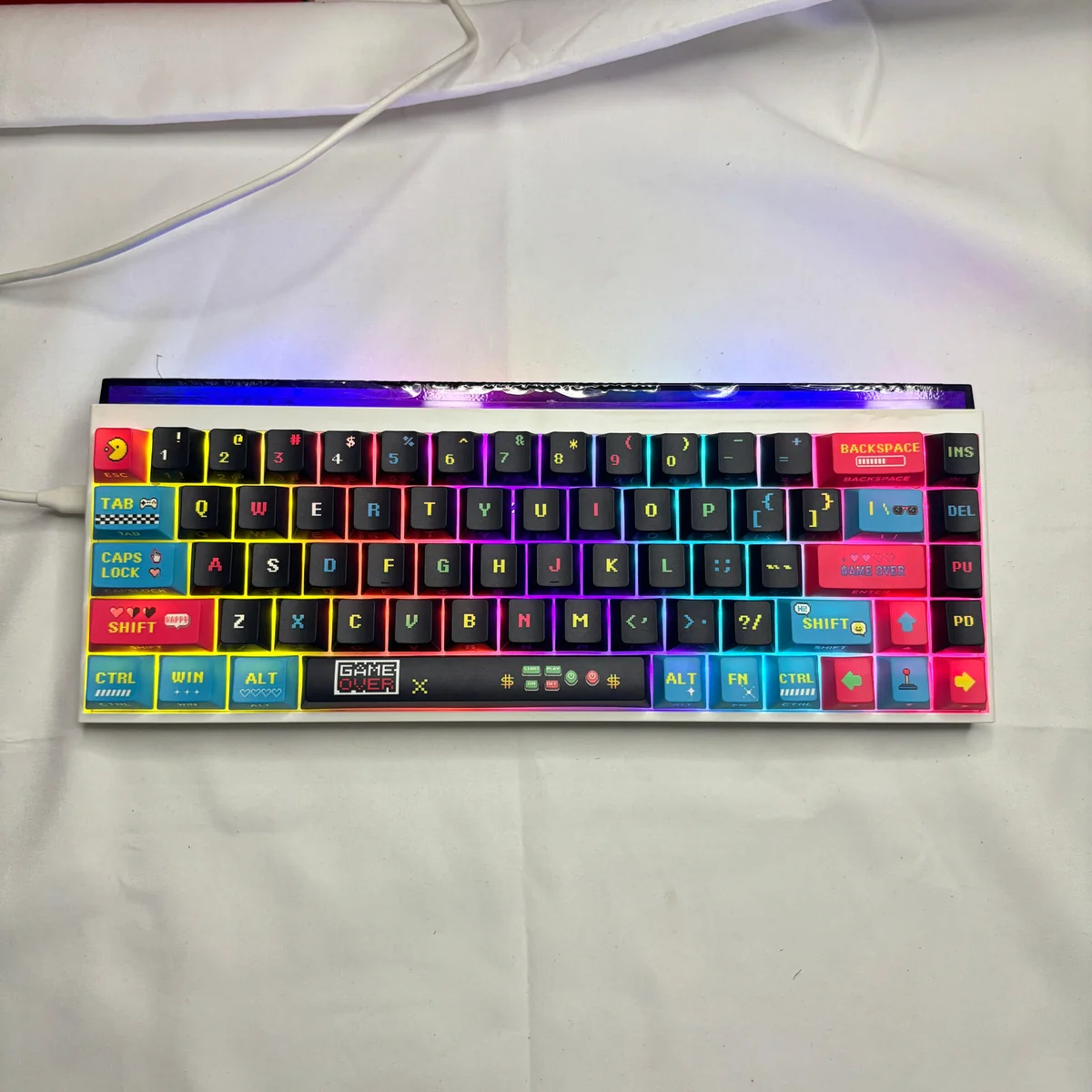 A collection of vibrant retro arcade Pixel Video Games art PBT keycaps set, showcasing their unique side-lit translucent legends from multiple playful angles.