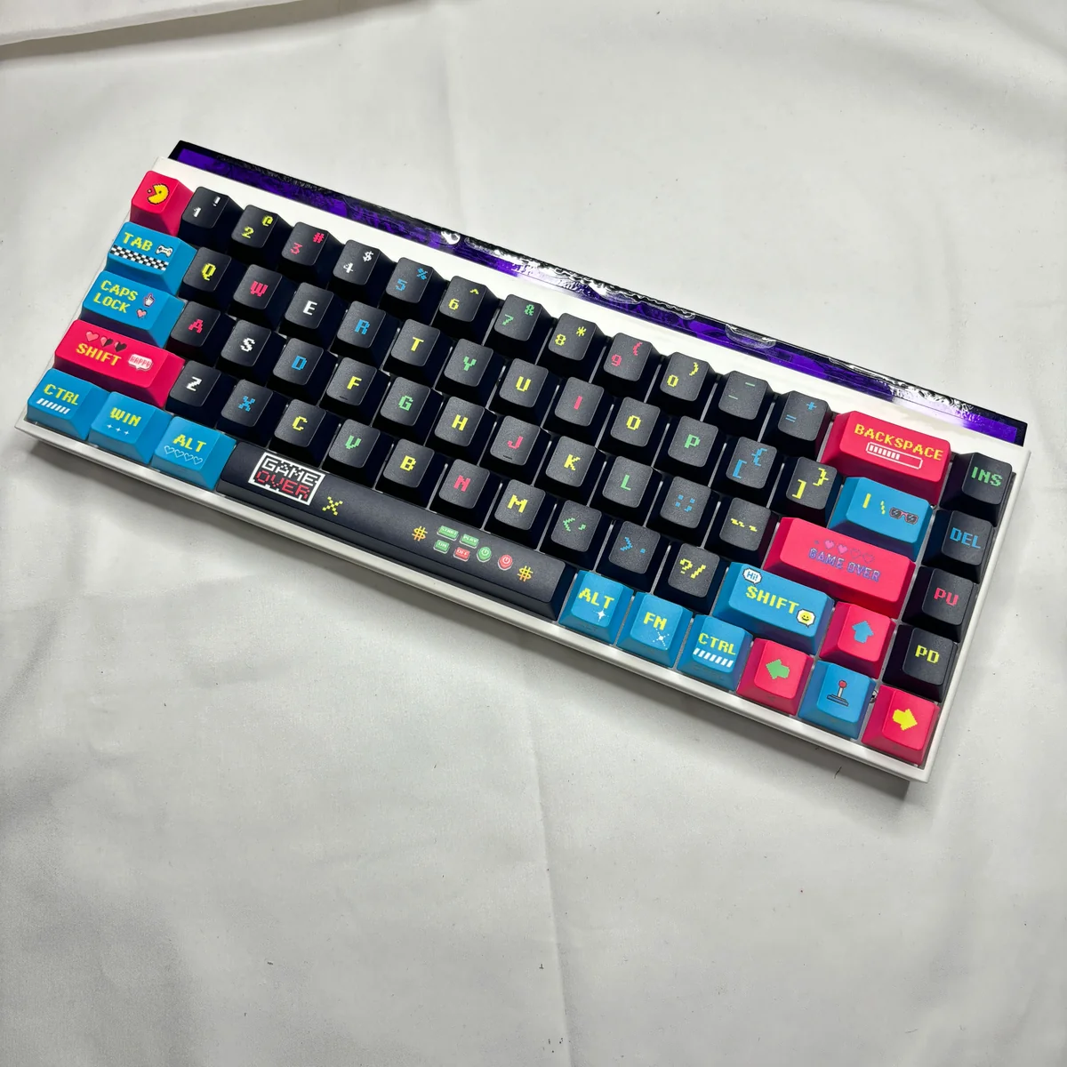 A playful 74-key set of Pixel Video Games Keycaps featuring vibrant retro arcade pixel art and dynamic side-lit translucent PBT, perfect for custom keyboards.