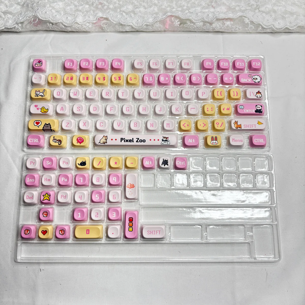 Pixel Zoo PBT Keycap Set, displayed from various angles, highlighting charming pixelated animal designs and vibrant, playful retro aesthetic.