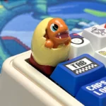 Close-up showcasing the vibrant, handcrafted Artisan Pokemon Hatching Resin ESC Keycap, with a charming character emerging from its detailed egg, ideal for fans.