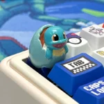 Detailed angled view of a handcrafted Artisan Pokemon Hatching Resin ESC Keycap, showcasing a vibrant Pokemon emerging from its egg, a unique artistic design.