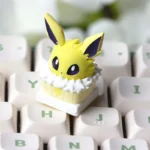 Close-up of the exclusive Jolteon cake-style artisan keycap, a charming Pokemon Keycap ESC, viewed from a delightful new angle.