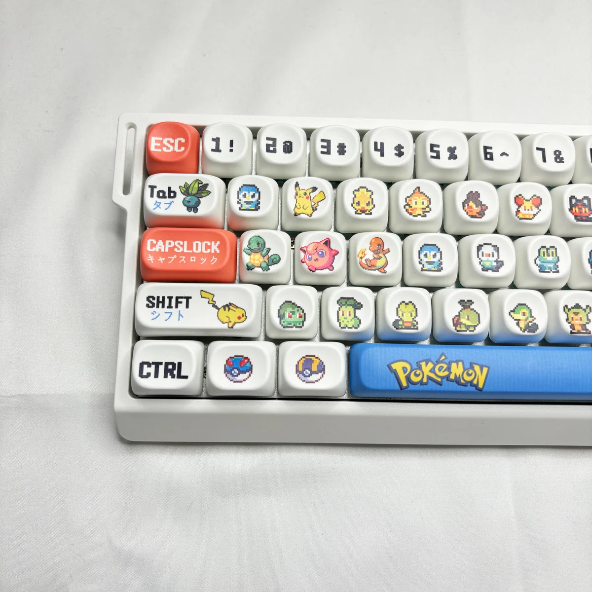 A vibrant Pokemon PBT MOA dye-sub keycap set is displayed from various angles, highlighting the nostalgic character designs and smooth, premium finish.