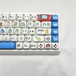 A close-up view of several vibrant Pokemon PBT MOA Dye-sub Keycaps Set, showcasing the playful character designs and premium feel from a unique angle.