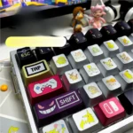 Close-up of a vibrant, premium metallic Pokemon artisan keycap set from multiple angles, showcasing its sleek finish and playful collectible design.