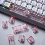 My Melody PBT backlit dye-sub keycap set, showcasing playful pastel pinks and translucent legends. Multiple angles highlight the iconic, whimsical My Melody design.