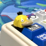 Vibrant, handcrafted Psyduck artisan Pokemon keycap for the ESC key, showcasing intricate resin details and artistic craftsmanship.