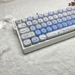 Whimsical Puppy Bagel PBT MOA keycaps set, featuring adorable puppy and bagel illustrations in soft colors, displayed from various angles. Durable PBT material.