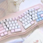 Whimsical Puppy PBT keycaps set, displaying charming puppy designs from various angles. This durable 150-key collection radiates a playful setup.