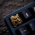 Views of the pure copper Qilin keycap, an artisan fortune charm. Intricate mythical Qilin sculpture with metallic luster, detailed from various angle.