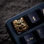 Fortune Qilin artisan keycap crafted from polished brass, featuring intricate mythical sculpture and a radiant metallic luster, a premium East Asian.