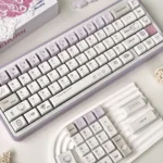 Purple Dazed Cat Series Keycap Set displayed from multiple angles, featuring charming minimalist cat designs in pastel and vibrant colors with diverse professional setup.