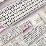 Purple Dazed Cat Series Keycap Set on a keyboard, featuring adorable minimalist cat designs in playful pastel hues. Enhance your keyboard's personality!