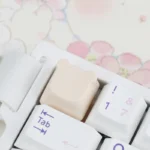 An adorable handcrafted resin bear keycap for the ESC key, presented from a charming side angle, highlighting its soft pastel colors and intricate artistic design.