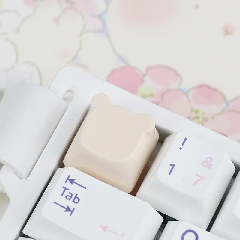 An adorable handcrafted resin bear keycap for the ESC key, presented from a charming side angle, highlighting its soft pastel colors and intricate artistic design.