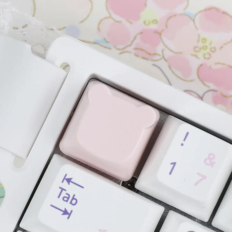 Adorable handcrafted resin bear artisan keycap for ESC key, viewed from a delightful side angle, revealing its soft pastel hues and charming detail.