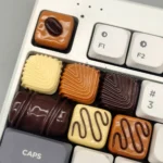 Close-up of Chocolate artisan resin low-shaft keycap, showcasing its dessert shell and stripe design with delectable hues and handcrafted detail.