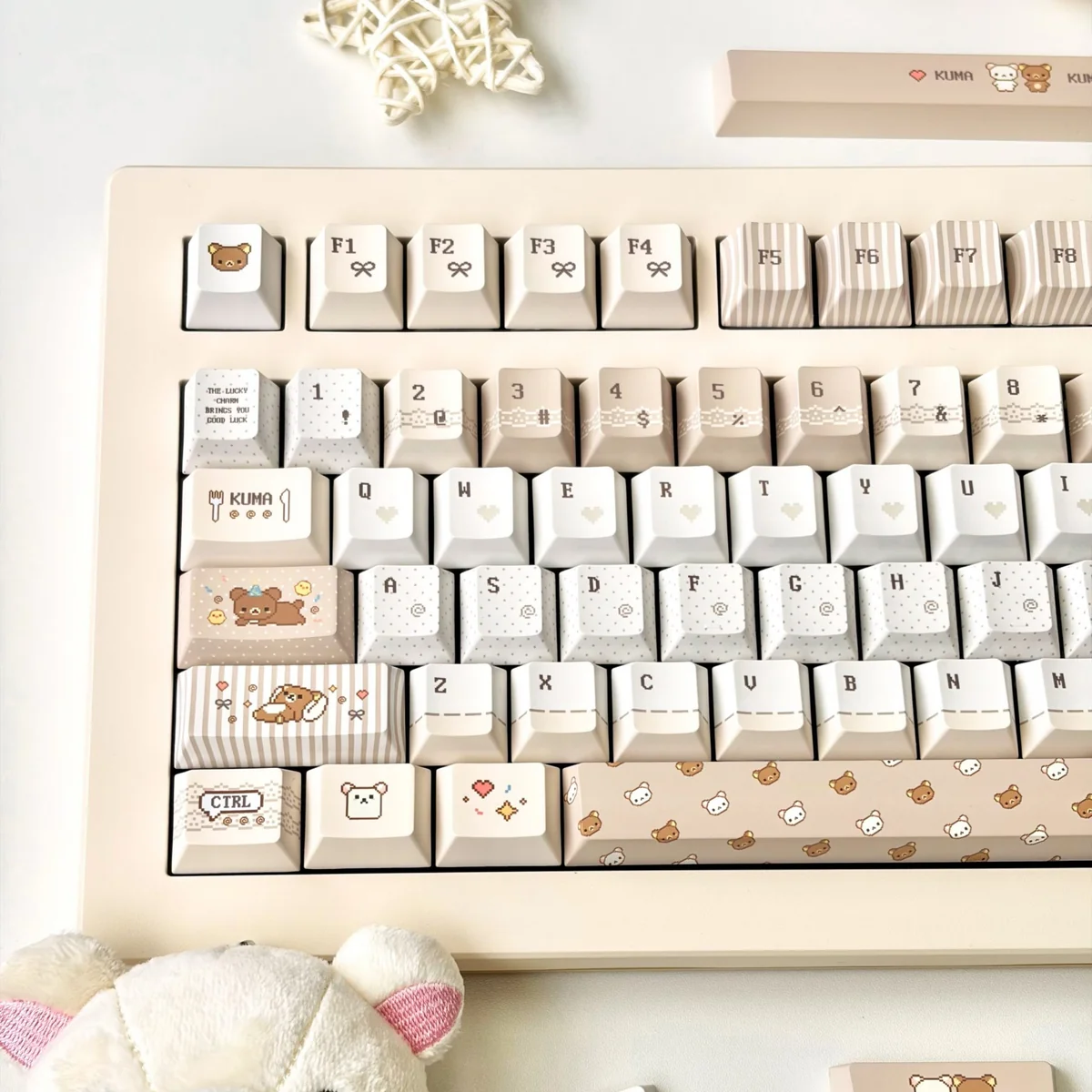 A playful collection of pixel Rilakkuma PBT dye-sub keycaps set, showcasing various adorable characters and cozy designs from different angles, perfect for fans.