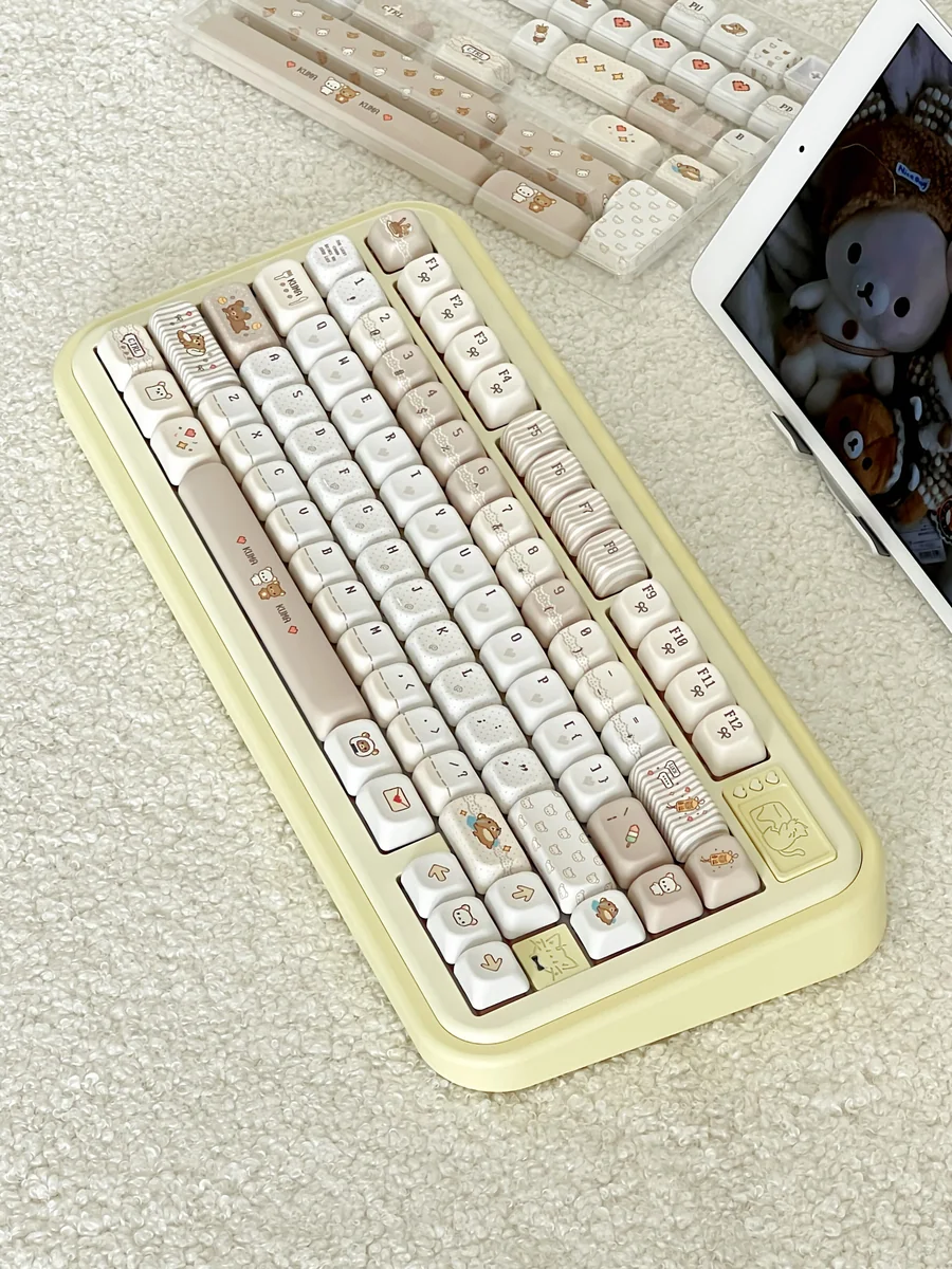 A whimsical set of Pixel Rilakkuma PBT Dye-Sub keycaps set, showcasing various angles of the charming pixel art characters for a cozy, nostalgic keyboard.