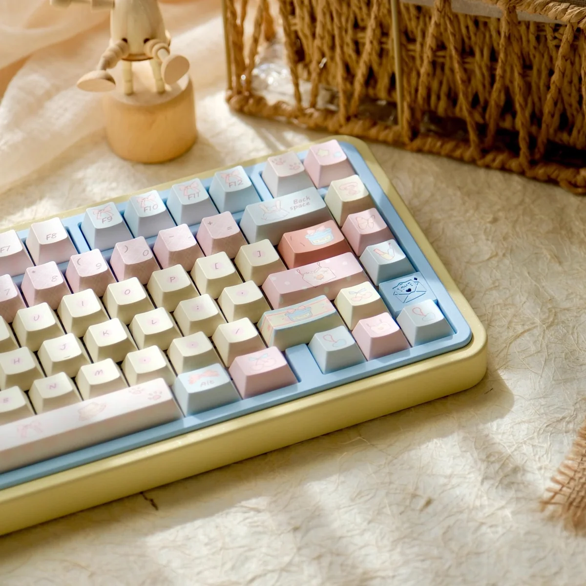 Close-up of a Romance Until Death PBT Dye-Sublimated Keycap Set, highlighting the dreamy pink, blue, and yellow hues arranged artistically.