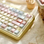 A collection of Romance Until Death PBT dye-sublimated keycaps set, showcasing the full 145-key set from various artistic angles with dreamy pink, blue, and yellow hues.