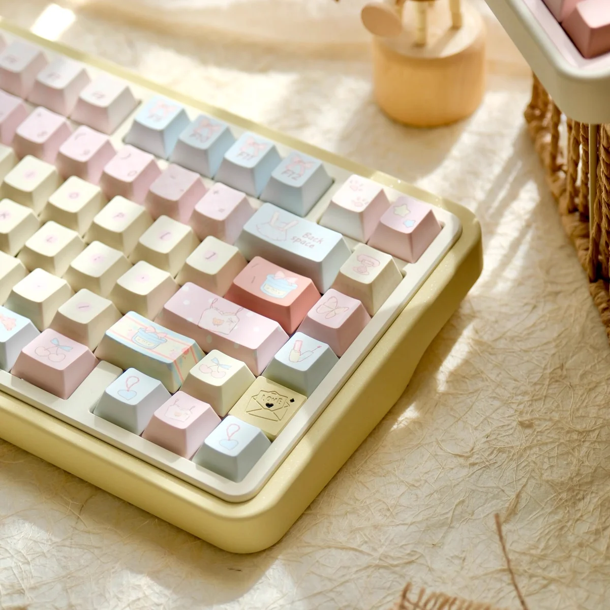 A collection of Romance Until Death PBT dye-sublimated keycaps set, showcasing the full 145-key set from various artistic angles with dreamy pink, blue, and yellow hues.