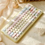 Romance Until Death PBT Dye-Sublimated Keycap Set showcasing a full keyboard with dreamy pink, blue, and yellow hues, evoking gentle serenity.