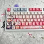 Exclusive Sakuraba Ema Magical Girl Dye-Sub PBT Keycaps Set. Gallery shows vibrant anime art, mystical 'witch trial' aesthetic from various angles.